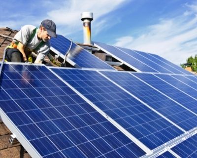 Roofing Systems:  Roofing in Welland: Installing Solar Panels  - solar panels on the roof with a technician working