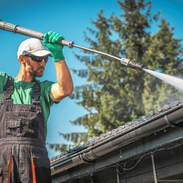 roofing contractors welland ontario - Is Moss on Your Roof a Problem - a worker pressure washing a roof