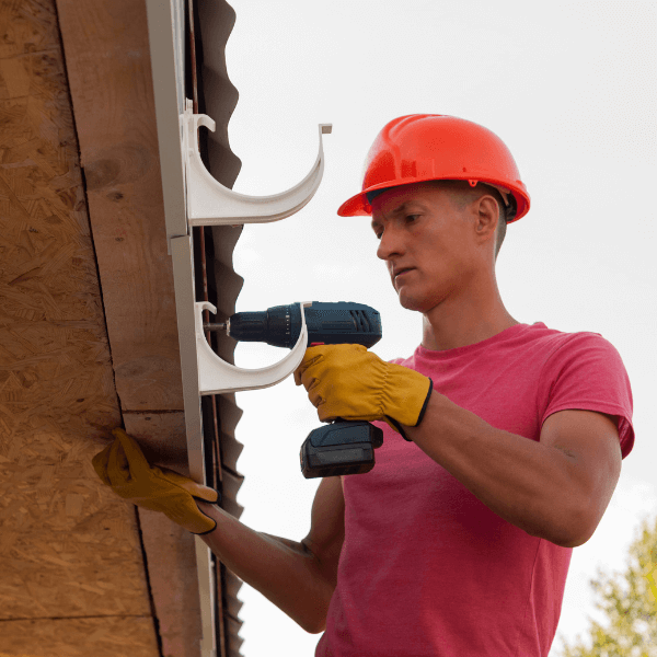 Roofing Companies Welland - Roofing Problems and Solutions - roofer attaching brackets for rain gutters
