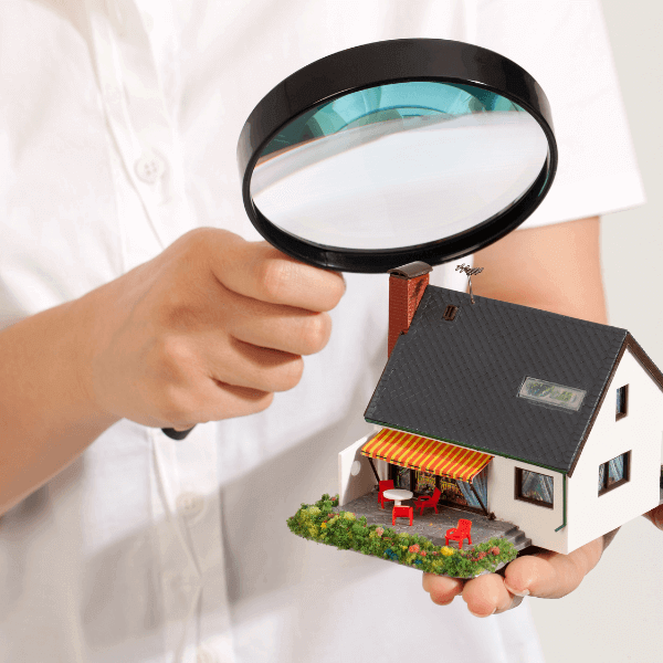 welland roofers - Roof Inspection Why It's Important and How to Do It - man holding a magnifying glass over a house model