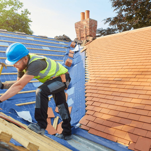 Welland roofing companies - How to Get The Most Out of Your Roofing or Siding Investment - roofer working on installing a new clay tile roof