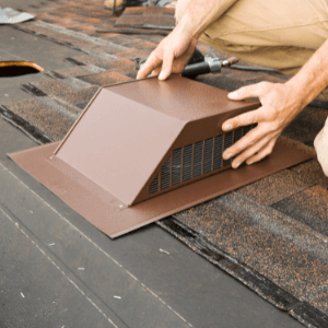 roofers welland - The Dos and Don'ts of Maintaining Your Roof - a roofer attaching a brown roof vent to a partially shingled roof