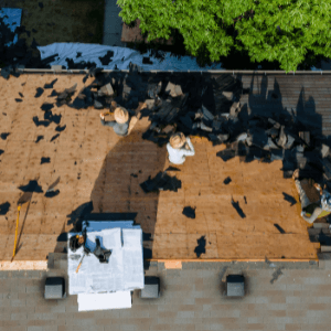 Replacing the Roof - an intricate roofing system with 4 levels and a chimney on the right