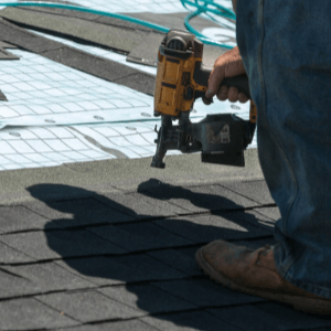 Replacing the Roof - an intricate roofing system with 4 levels and a chimney on the right