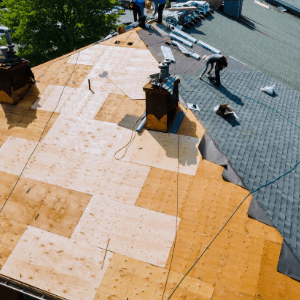 Replacing the Roof - an intricate roofing system with 4 levels and a chimney on the right